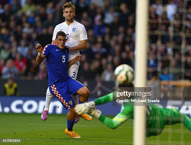 Luke Shaw of England shoots past Matej Delac of Croatia only to see his shot hit the post during the UEFA U21 Championship Playoff First Leg match...