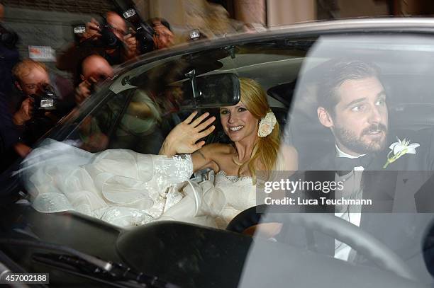 Michelle Hunziker leaves her wedding with her new husband Tomaso Trussardi at Palazzo della Ragione on October 10, 2014 in Bergamo, Italy.