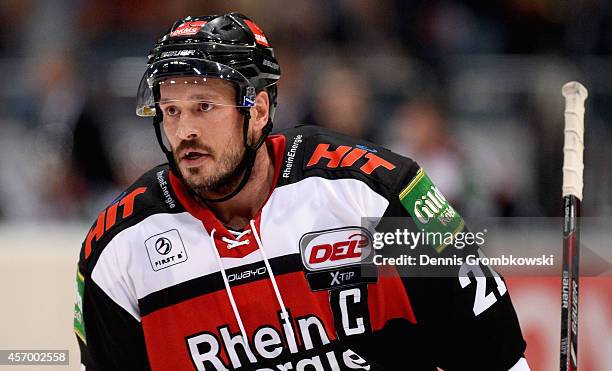 John Tripp of Koelner Haie looks on during the DEL Ice Hockey match between Koelner Haie and Krefeld Pinguine at Lanxess Arena on October 10, 2014 in...