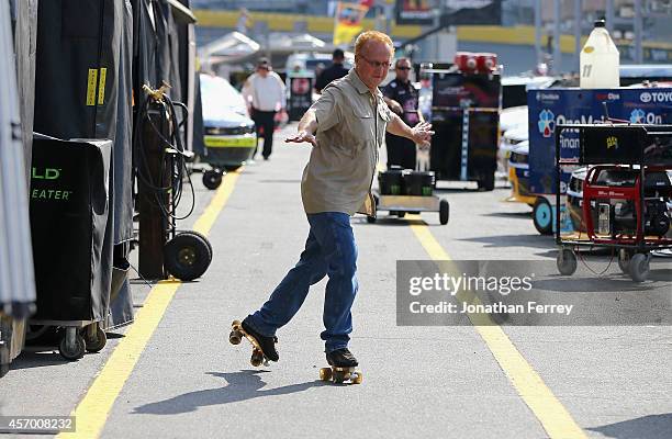 Morgan Shepherd, driver of the Courtney Construction Chevrolet, roller skates through the garage area prior to practice for the NASCAR Nationwide...