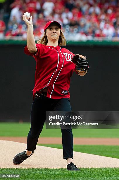 Swimmer Katie Ledecky throws the ceremonial first pitch for Game One of the National League Division Series between the Washington Nationals and the...