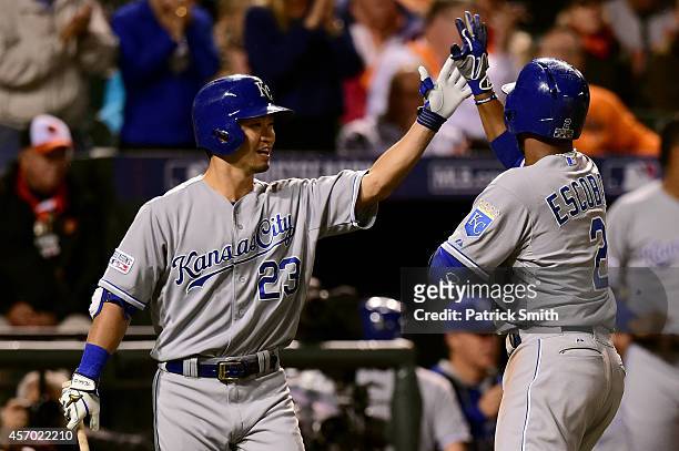 Alcides Escobar of the Kansas City Royals celebrates with teammate Norichika Aoki after hitting a solo home run to left field in the third inning...