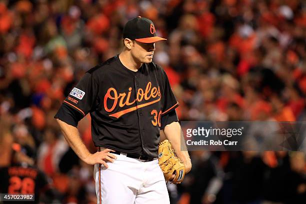 Chris Tillman of the Baltimore Orioles reacts after giving up a home run to Alcides Escobar of the Kansas City Royals in the third inning during Game...