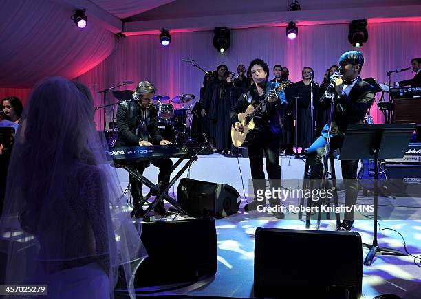 Jonathan Cain, Neal Schon, and Arnel Pineda perform for Michaele Schon during the wedding of Michaele Schon and Neal Schon at the Palace of Fine Arts...