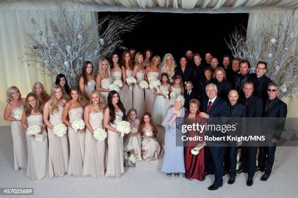 Neal Schon and Michaele Schon pose with their bridal party at their wedding at the Palace of Fine Arts on December 15, 2013 in San Francisco,...