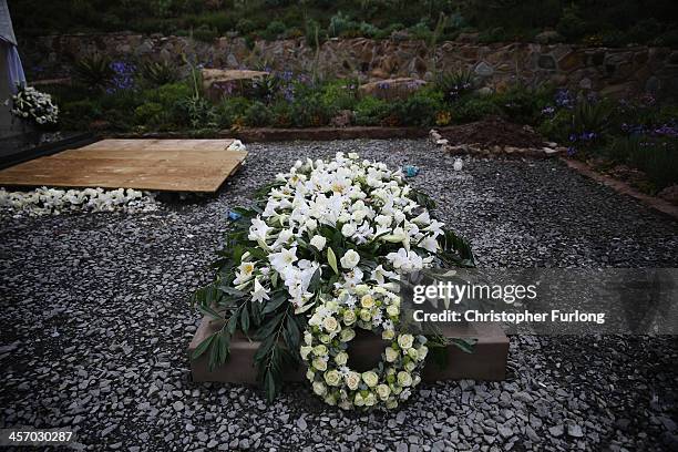 The grave of former South African President Nelson Mandela is covered with flowers in is home village of Qunu on December 16, 2013 in Qunu, South...