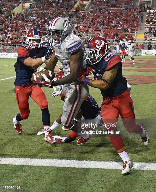 Kendal Keys of the UNLV Rebels catches a touchdown pass in the end zone against Brandon Hughes, Malcolm Washington and Derron Smith of the Fresno...