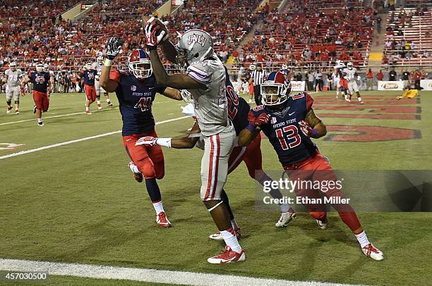 Kendal Keys of the UNLV Rebels catches a touchdown pass in the end zone against Brandon Hughes, Malcolm Washington and Derron Smith of the Fresno...