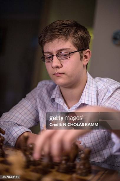 Thirteen year-old chess player Samuel Sevian plays against his father Armen Sevian in Alexandria, Virginia, on October 9, 2014. Sevian is on course...