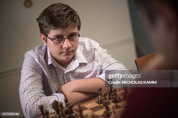 Thirteen year-old chess player Samuel Sevian looks at his father Armen Sevian as they play a game in Alexandria, Virginia, on October 9, 2014. Sevian...