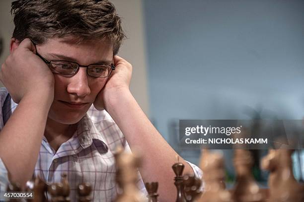 Thirteen year-old chess player Samuel Sevian ponders a move as he plays against his father in Alexandria, Virginia, on October 9, 2014. Sevian is on...