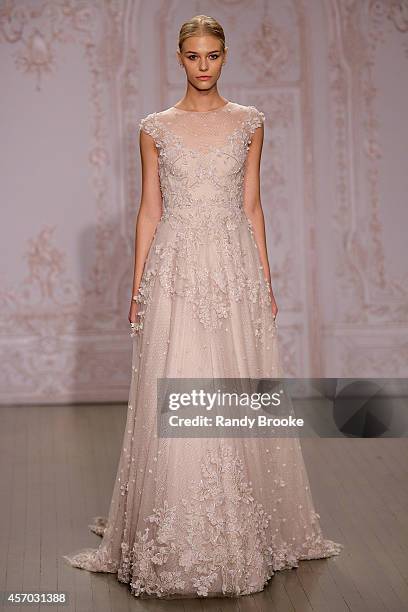 Model walks the runway during the Fall 2015 Monique Lhuillier Bridal Show on October 10, 2014 in New York City.