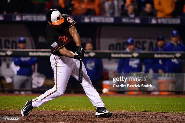 Delmon Young of the Baltimore Orioles hits a single to center field in the tenth inning against Greg Holland of the Kansas City Royals during Game...