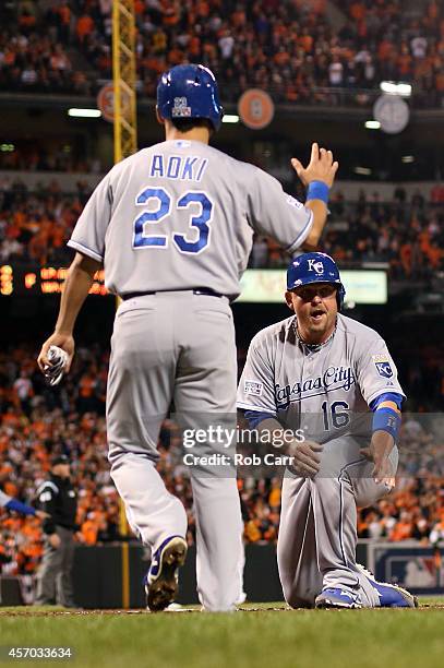 Billy Butler slides safe to home plate on Alex Gordon of the Kansas City Royals double to right field also scoring Aoki and Cain because of an error...