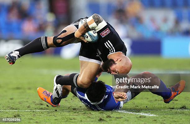 Forbes of New Zealand is tackled by Tofatuimoana Solia of Samoa during the 2014 Gold Coast Sevens Pool A match between New Zealand and Samoa at Cbus...