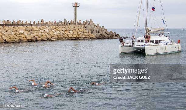 Six Israeli swimmers arrive at the Marina in the Israeli coastal city of Herzliya after swimming in turns 400 kms from the Mediterranean island of...