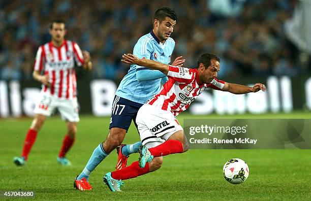 Massimo Murdocca of Melbourne City gets to the ball ahead of Terry Antonis of Sydney FC during the round one A-League match between Sydney FC and...