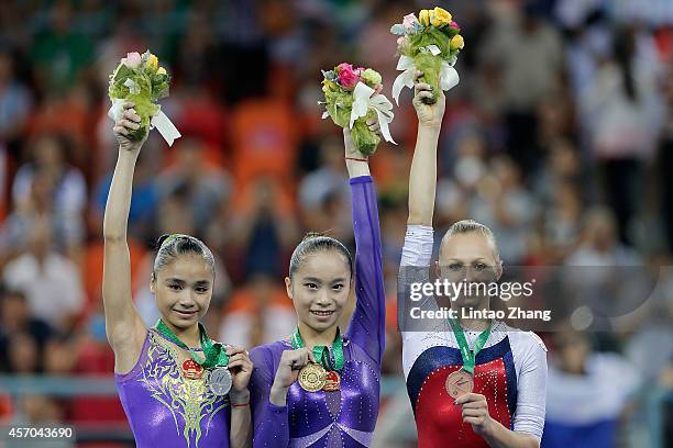 Silver medalist Huang Huidan of China, gold medalist Yao Jinnan of China and bronze medalist Daria Spiridonova of Russia celebrates during the medal...