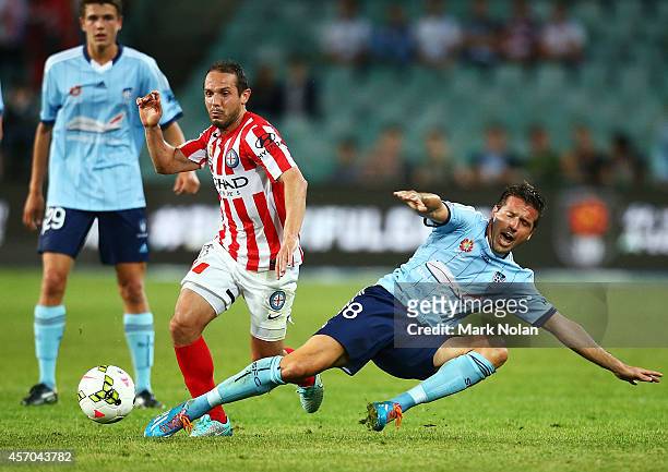 Massimo Murdocca of Melbourne and Milos Dimitrijevic of Sydney contest possession during the round one A-League match between Sydney FC and Melbourne...