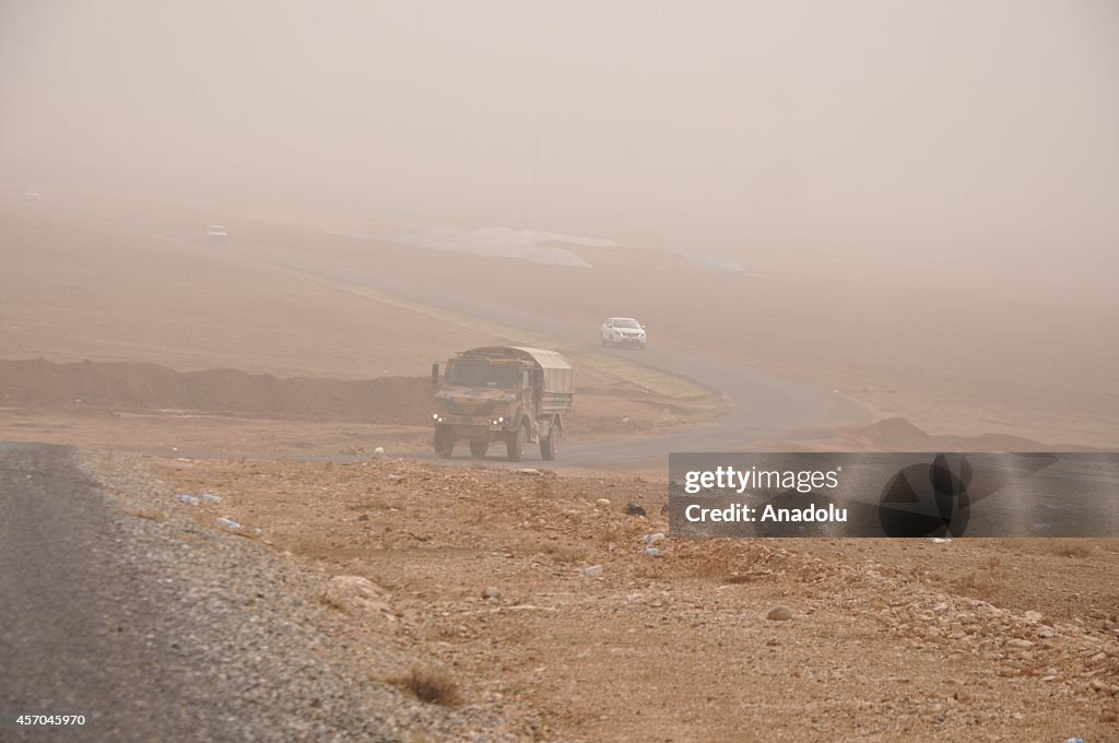 Vehicles in floating dust weather on Turkey's Syrian border