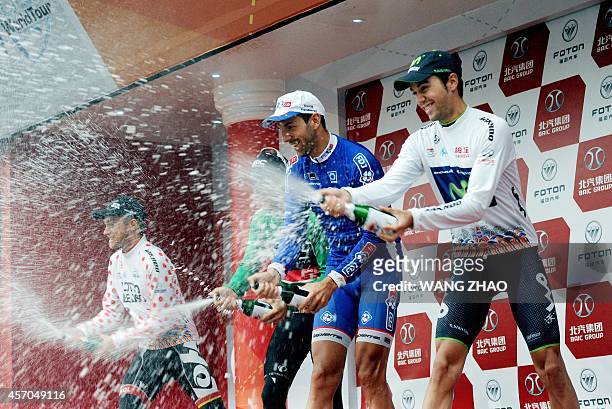 Herrada Lopez Jesus of Movistar team , Mangel Laurent , Gilbert Philippe and Van Der Sande Tosh spray champagne on the podium after the second stage...