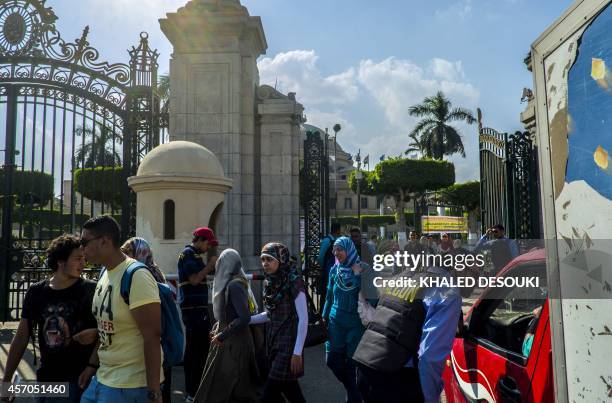 An Egyptian security man from a private company stops a vehicle at the gates of Cairo University in the Egyptian capital on October 11 as students...