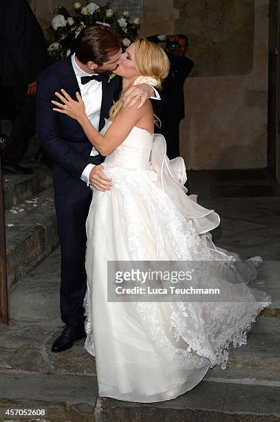 Michelle Hunziker leaves her wedding with her new husband Tomaso Trussardi at Palazzo della Ragione on October 10, 2014 in Bergamo, Italy.
