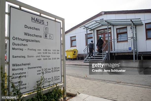 Unidentified refugees enter the accommodation building at the refugee center on December 10, 2013 in Friedland, Germany. Hundreds of thousands of...