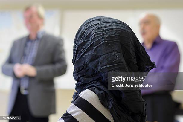Unidentified Syrian refugee sits in a "Welcome in Germany" seminar at the refugee center on December 10, 2013 in Friedland, Germany. Hundreds of...