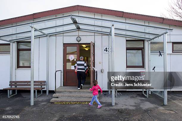 Unidentified Syrian refugees enter their living quarters at the refugee center on December 10, 2013 in Friedland, Germany. Hundreds of thousands of...