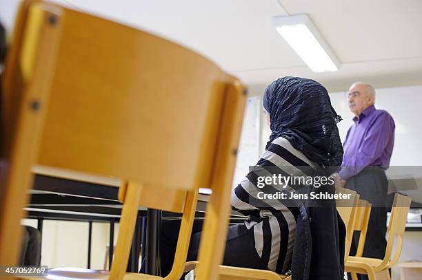 Unidentified Syrian refugee sits in a "Welcome in Germany" seminar at the refugee center on December 10, 2013 in Friedland, Germany. Hundreds of...