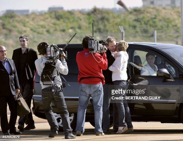 French TV host Elise Lucet kisses former hostage, French reporter Herve Ghesquiere upon his arrival with cameraman Stephane Taponier released the day...