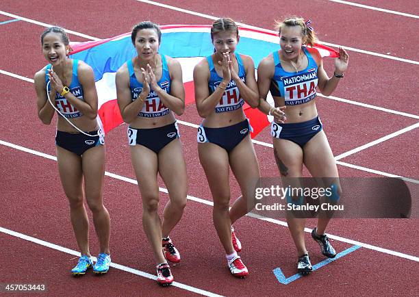 Thailand Women's 4 x 100m Relay Team celebrate after winning the Final of the 4 x100m Relay of the Athletics Day Two Competition during the 2013 SEA...