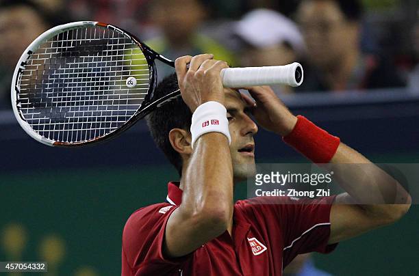 Novak Djokovic of Serbia reacts during his semi final match against Roger Federer of Switzerland during the day 7 of the Shanghai Rolex Masters at...
