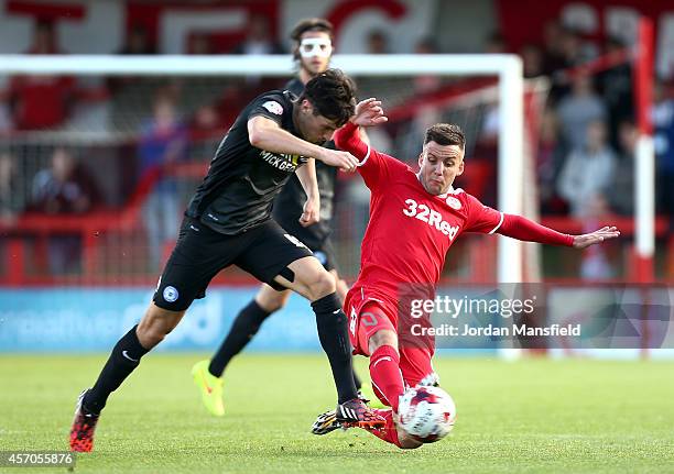 Jimmy Smith of Crawley tackles Joe Newell of Peterborough during the Sky Bet League One match between Crawley Town and Peterborough United at...