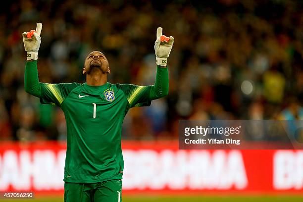 Goalkeeper Jefferson of Brazil celebrates after saving Lionel Messi's penalty kick during a match between Argentina and Brazil as part of 2014...
