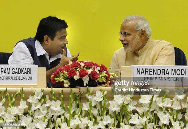 Prime Minister Narendra Modi along with Union Minister for Rural Development Nitin Gadkari during the launch of Saansad Adarsh Gram Yojana , on...