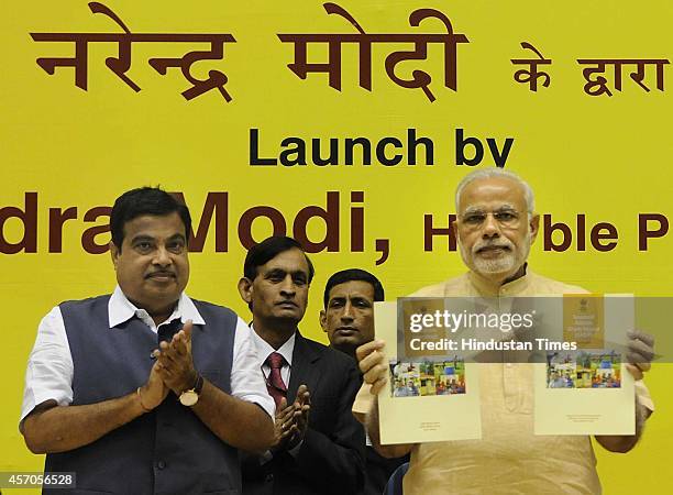 Prime Minister Narendra Modi along with Union Minister for Rural Development Nitin Gadkari during the launch of Saansad Adarsh Gram Yojana , on...