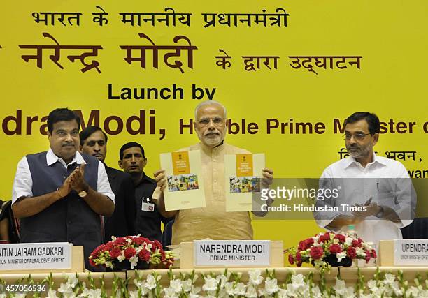 Prime Minister Narendra Modi along with Union Minister for Rural Development Nitin Gadkari during the launch of Saansad Adarsh Gram Yojana , on...