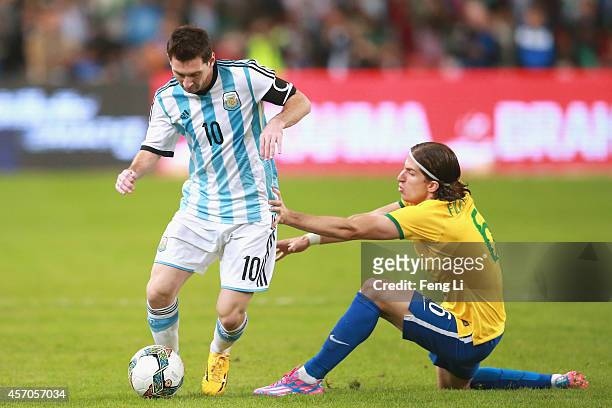 Filipe Luis of Brazil competes the ball with Lionel Messi of Argentina during Super Clasico de las Americas between Argentina and Brazil at Beijing...