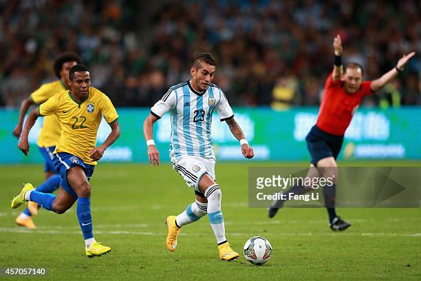 Pereyra of Argentina competes the ball with Pastore of Brazil during Super Clasico de las Americas between Argentina and Brazil at Beijing National...