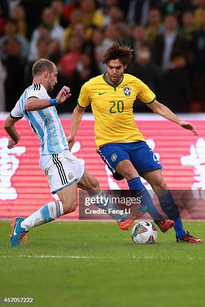 Kaka of Brazil competes the ball with Zabaleta of Argentina during Super Clasico de las Americas between Argentina and Brazil at Beijing National...