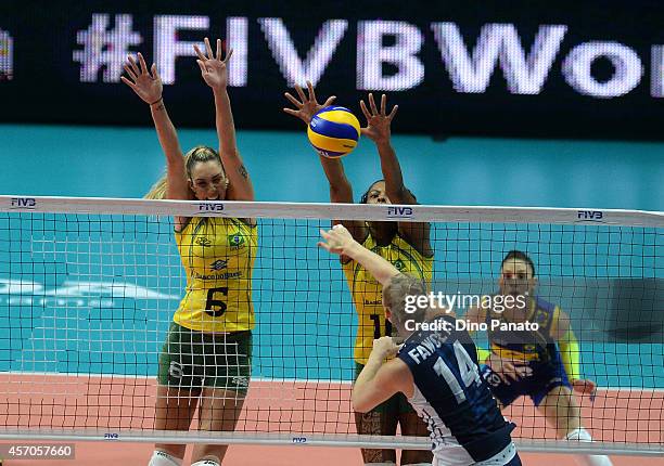 Nicole Fawcett of USA spikes the ball against to Thaisa Menezes and Fernanda Rodrigues of Brazil during the FIVB Women's World Championship...