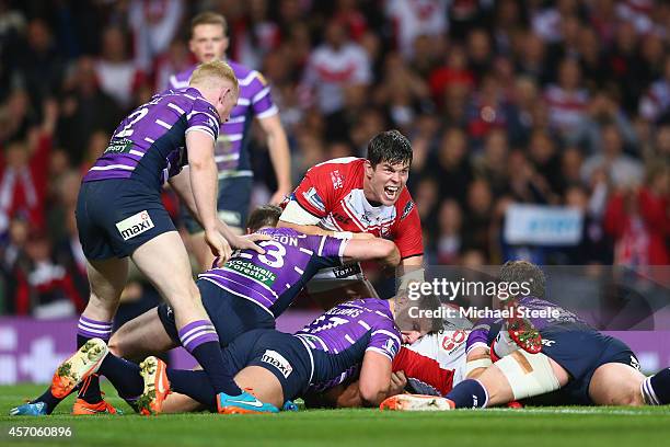 Louie McCarthy-Scarsbrook of St Helens celebrates his sides opening try scored by Sia Soliola during the First Utility Super League Grand Final match...
