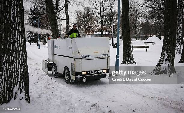 Weather pictures in the Beaches: Matthew Parker resurfaces the ice with the Zamboni at the Kew Gardens skating rink and when that's done he puts it...