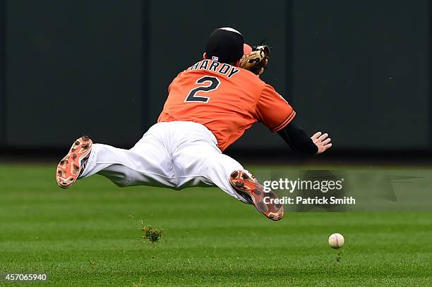 Hardy of the Baltimore Orioles misses a ball hit by Eric Hosmer of the Kansas City Royals single to left field scoring Norichika Aoki and Lorenzo...