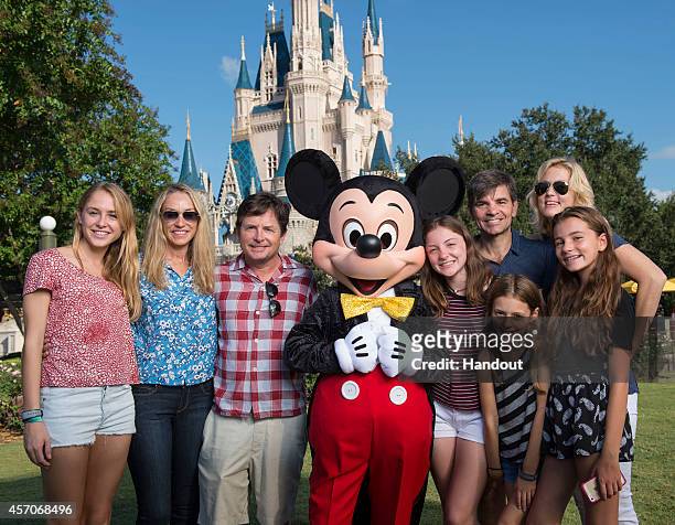 In this handout photo provided by Disney Parks, acting legend Michael J. Fox and ABC News' chief anchor/"Good Morning America" anchor George...