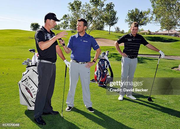 Todd Lewis of the Golf Channel holds the microphone for John Mallinger as Luke List looks on at a golf clinic at the TPC Las Vegas during the 2014...