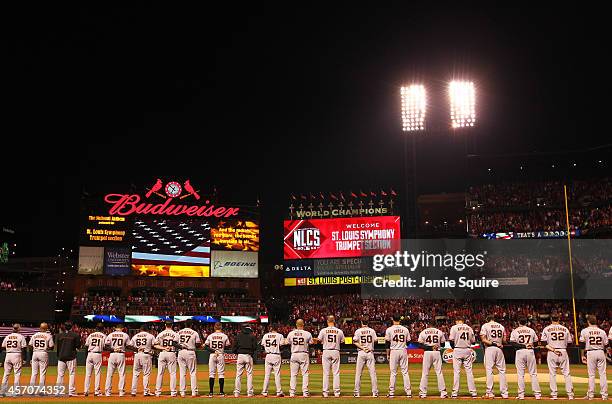 The San Francisco Giants line up during pre-game ceremonies for Game One of the National League Championship Series against the St. Louis Cardinals...