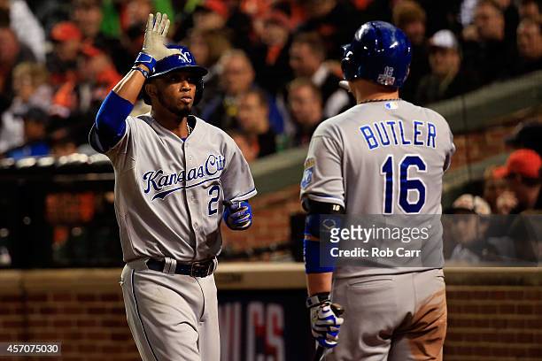 Alcides Escobar celebrates with teammate Billy Butler after scoring on Lorenzo Cain of the Kansas City Royals RBI single to left field in the ninth...